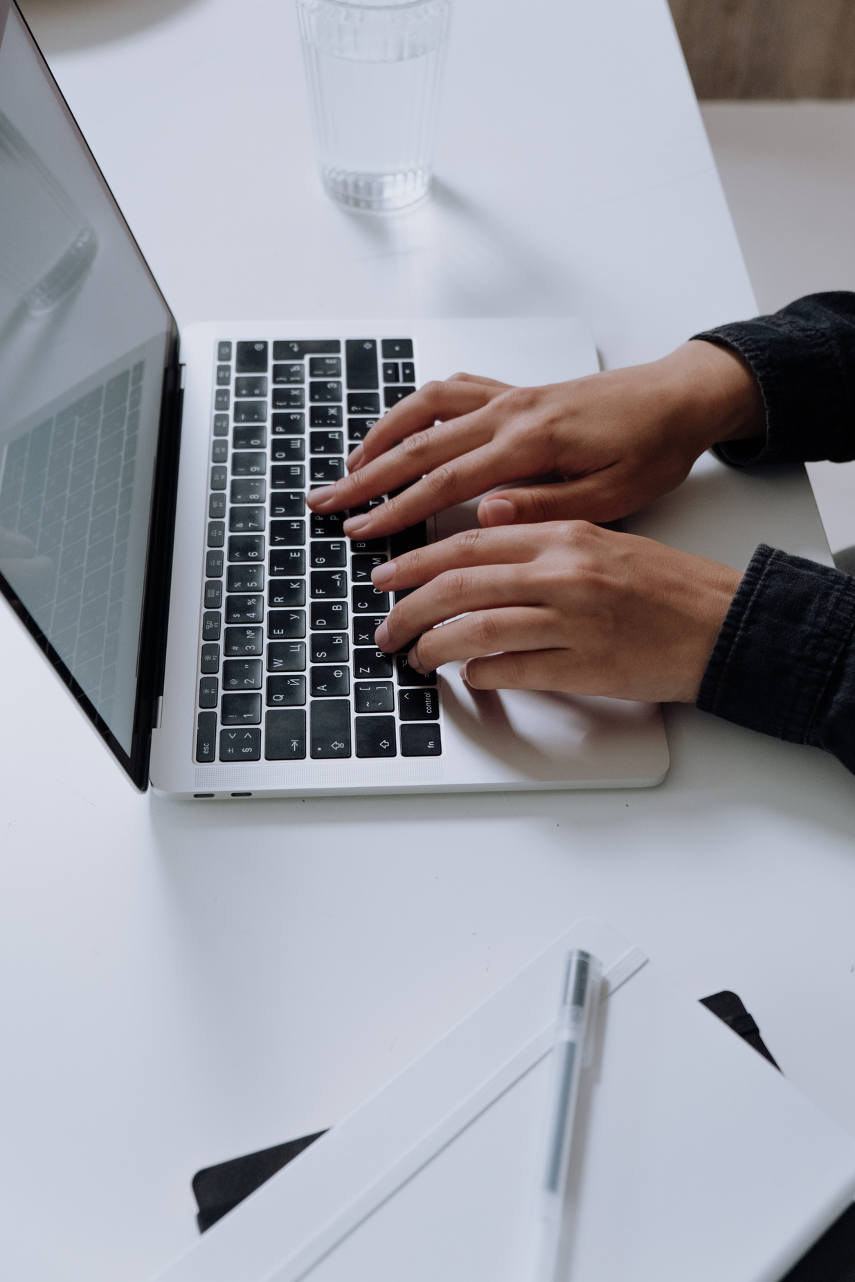 Person Using Macbook Pro on White Table